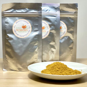 Organic sea buckthorn powder from Estonia in sample packs and on a plate