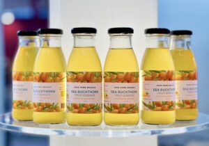 Organic sea buckthorn fruit essence from Estonia – 250ml glass bottles on display