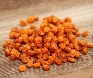 Freeze-dried sea buckthorn berries on a rustic table.