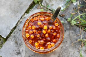 Dried sea buckthorn berries in glass jar.